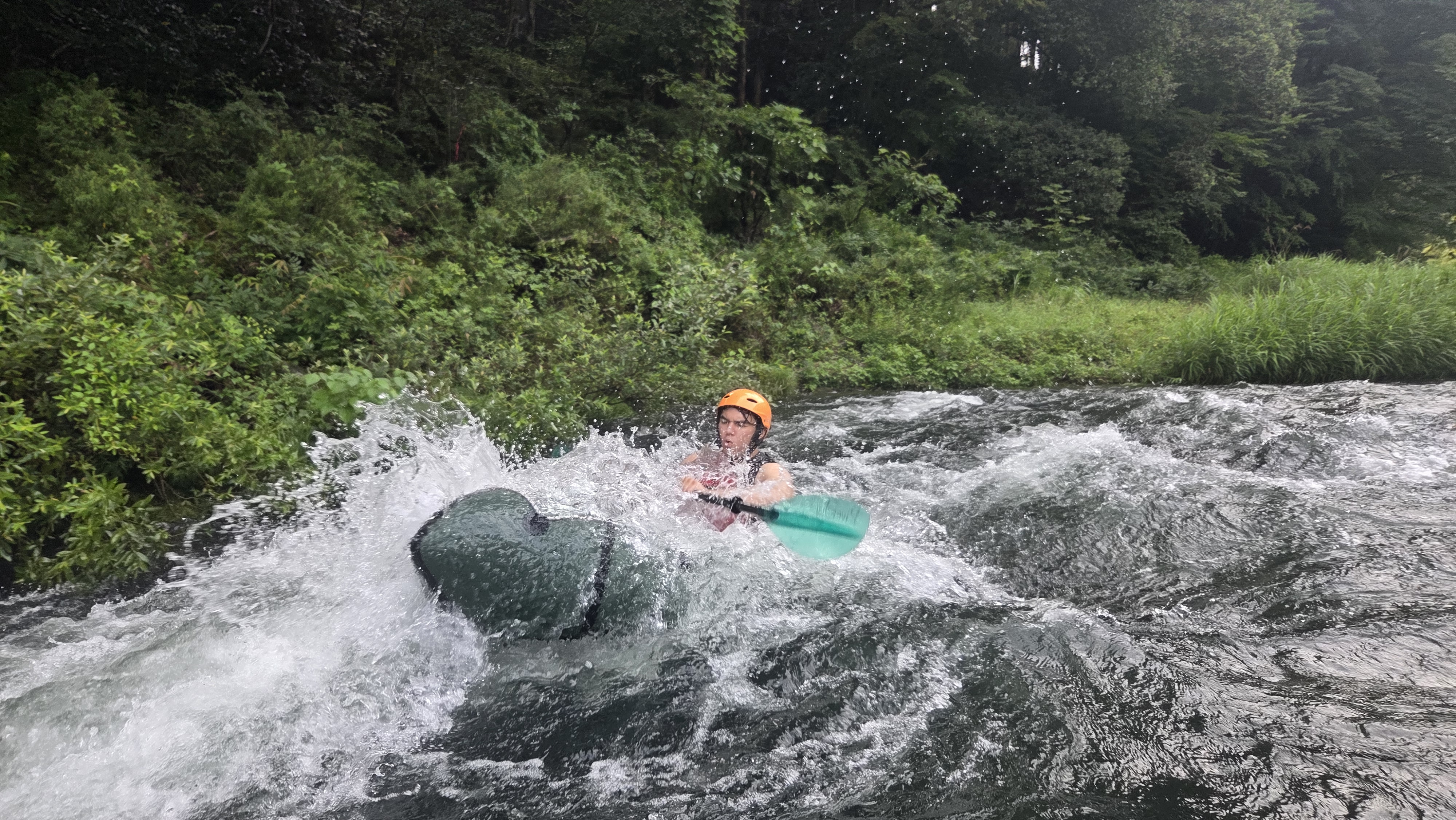 Pack Raft guest paddling through stronger whitewater on a harder course in Japan